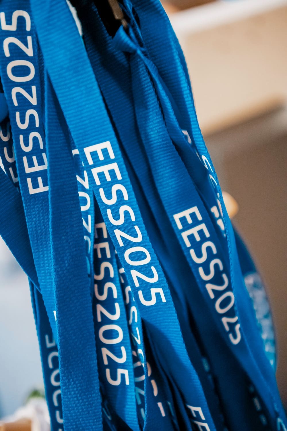 Bundle of printed blue lanyards, shot with a shallow depth of field.